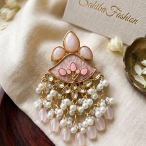 Baby Pink Kundan Drop Earrings with pearl bead danglers and gold-tone detailing displayed on a soft beige fabric background.