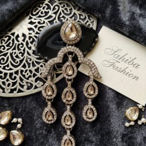 Sahiba Fashion champagne stone tiered drop earrings with crystal tassels on velvet background.