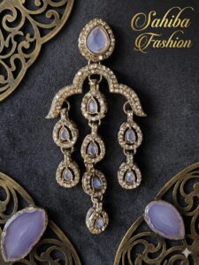 Close-up of a Sahiba Fashion chandelier earring featuring soft lavender stones and gold crystal borders.