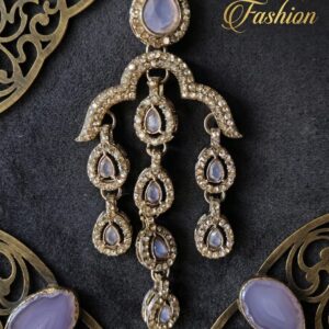 Close-up of a Sahiba Fashion chandelier earring featuring soft lavender stones and gold crystal borders.