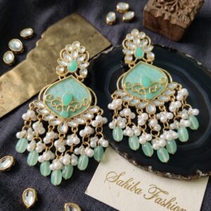 Heavy mint green kundan chandbali earrings with intricate gold filigree and pearl bead tassels.