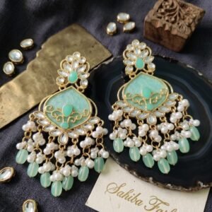 Heavy mint green kundan chandbali earrings with intricate gold filigree and pearl bead tassels.