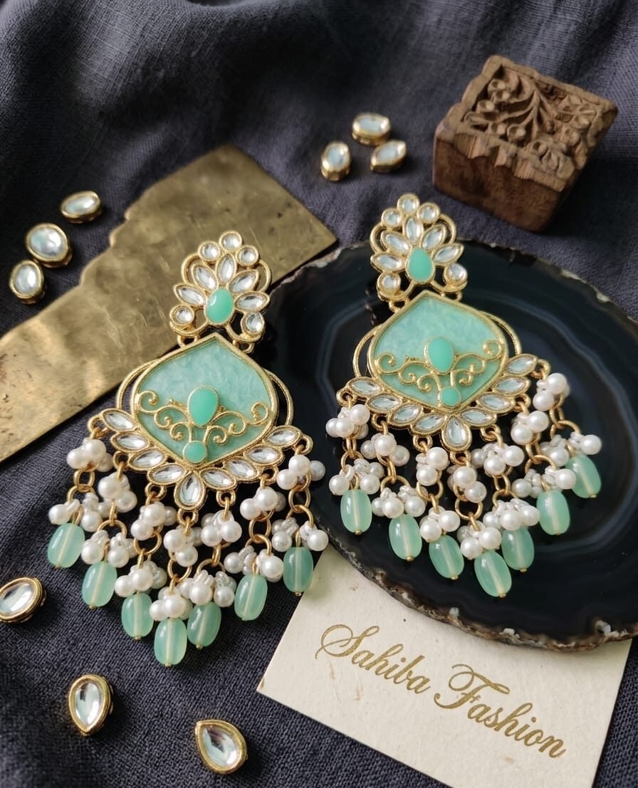 mint green kundan pearl chandbali earrings.jpg Heavy mint green kundan chandbali earrings with intricate gold filigree and pearl bead tassels.