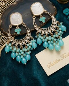 Large kundan earrings with mother of pearl studs and turquoise blue bead clusters.