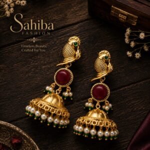 Golden peacock motif jhumka earrings with red stone, pearl and green bead detailing