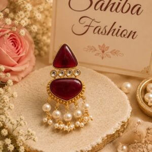 Sahiba Fashion designer maroon gemstone earrings with pearl accents on gold-rimmed pedestal
