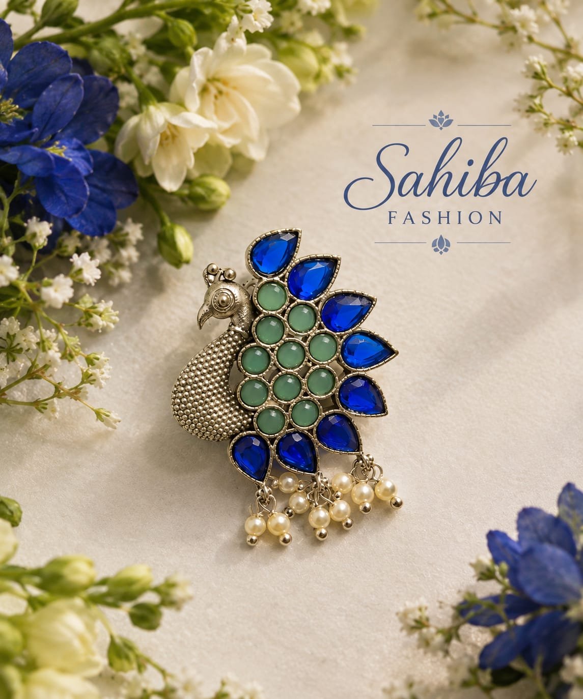 peacock shaped silver stud earrings with green & blue stone & pearls mockup 3 Handcrafted silver peacock statement earring with mint and blue stones framed by white and blue flowers.