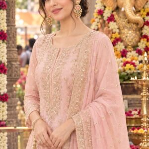 Model wearing gold elephant motif earrings with pink centerpiece paired with a pink embroidered suit.