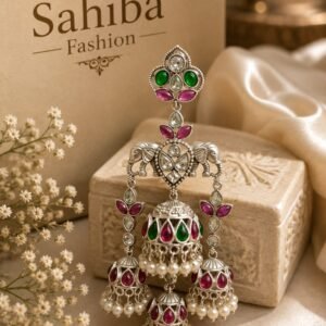 Sahiba Fashion multi-tiered silver elephant jhumka earrings with pink and green stones displayed on a gold stand.