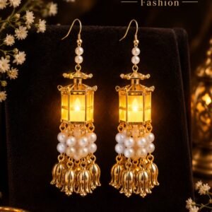 Sahiba Fashion viral LED glowing lantern earrings displayed on a dark velvet stand with white floral accents and traditional brass decor.